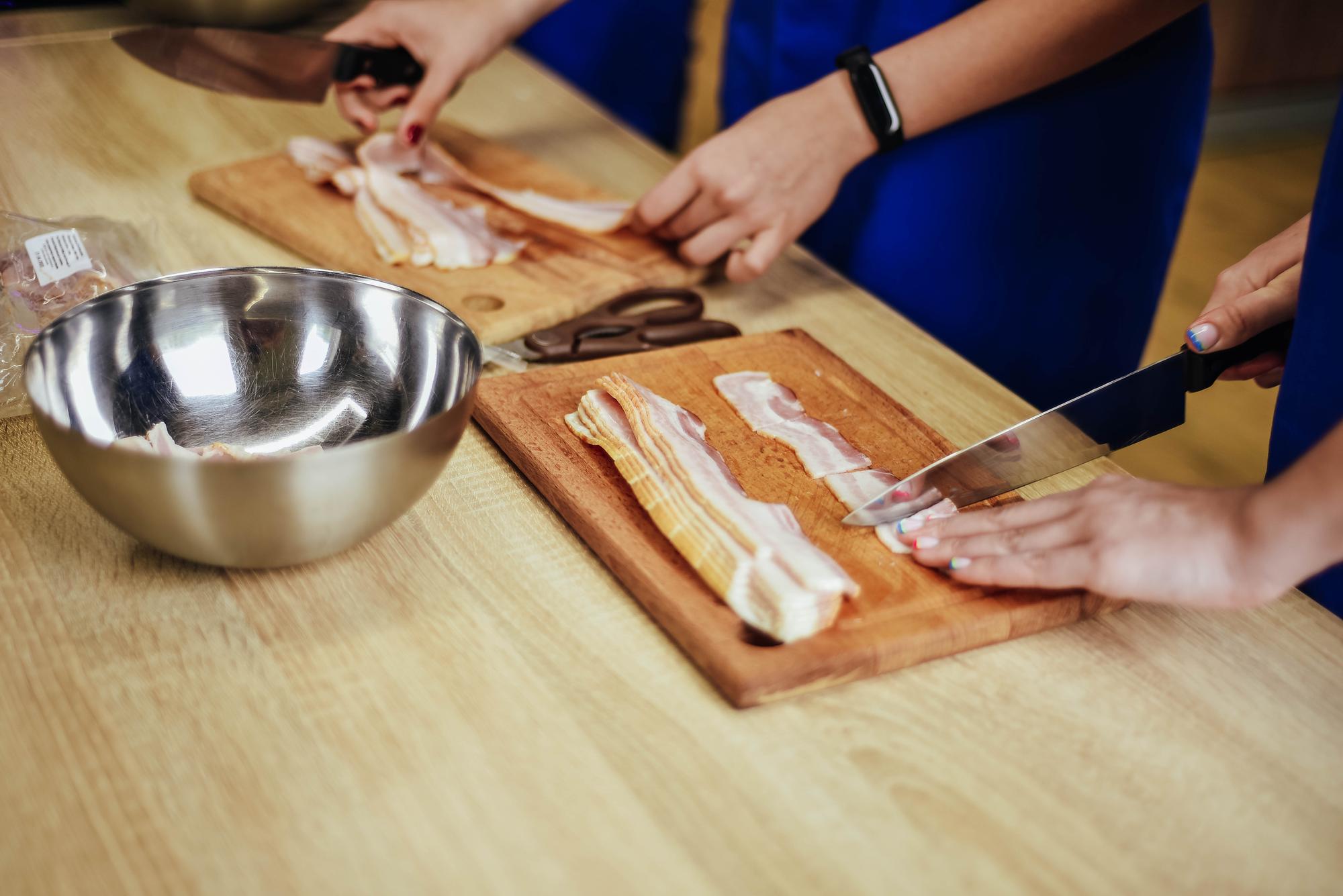 Small group around bench learning knife skills