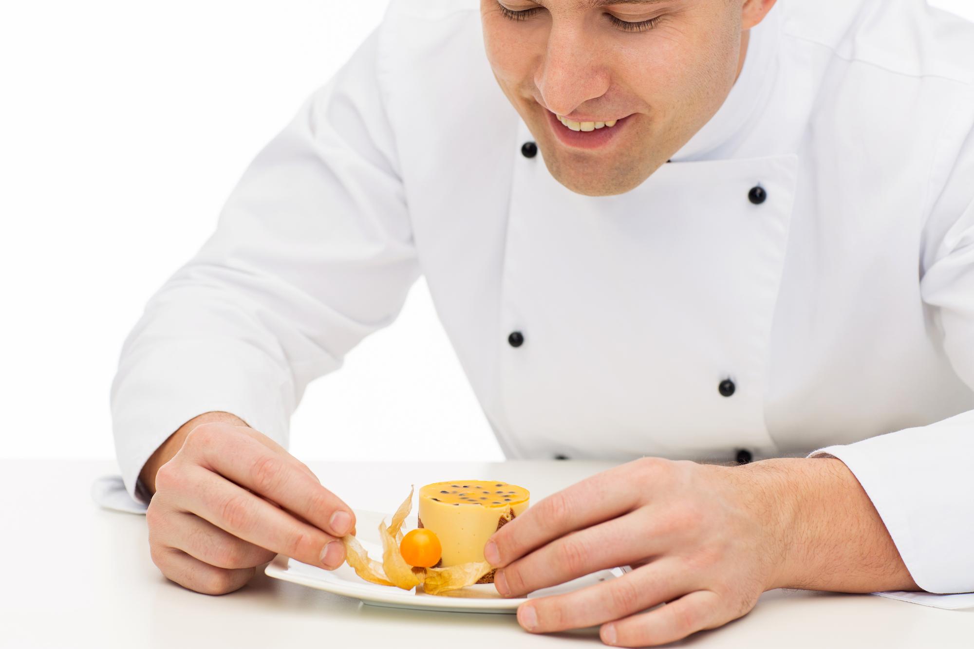 Instructor plating a modern dish in a bright kitchen
